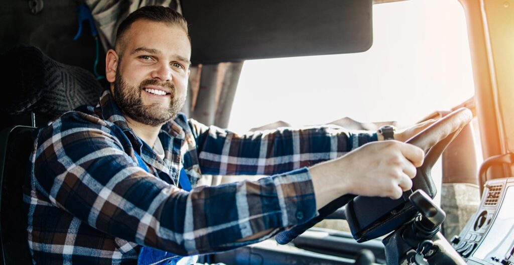 man driving in truck smiling